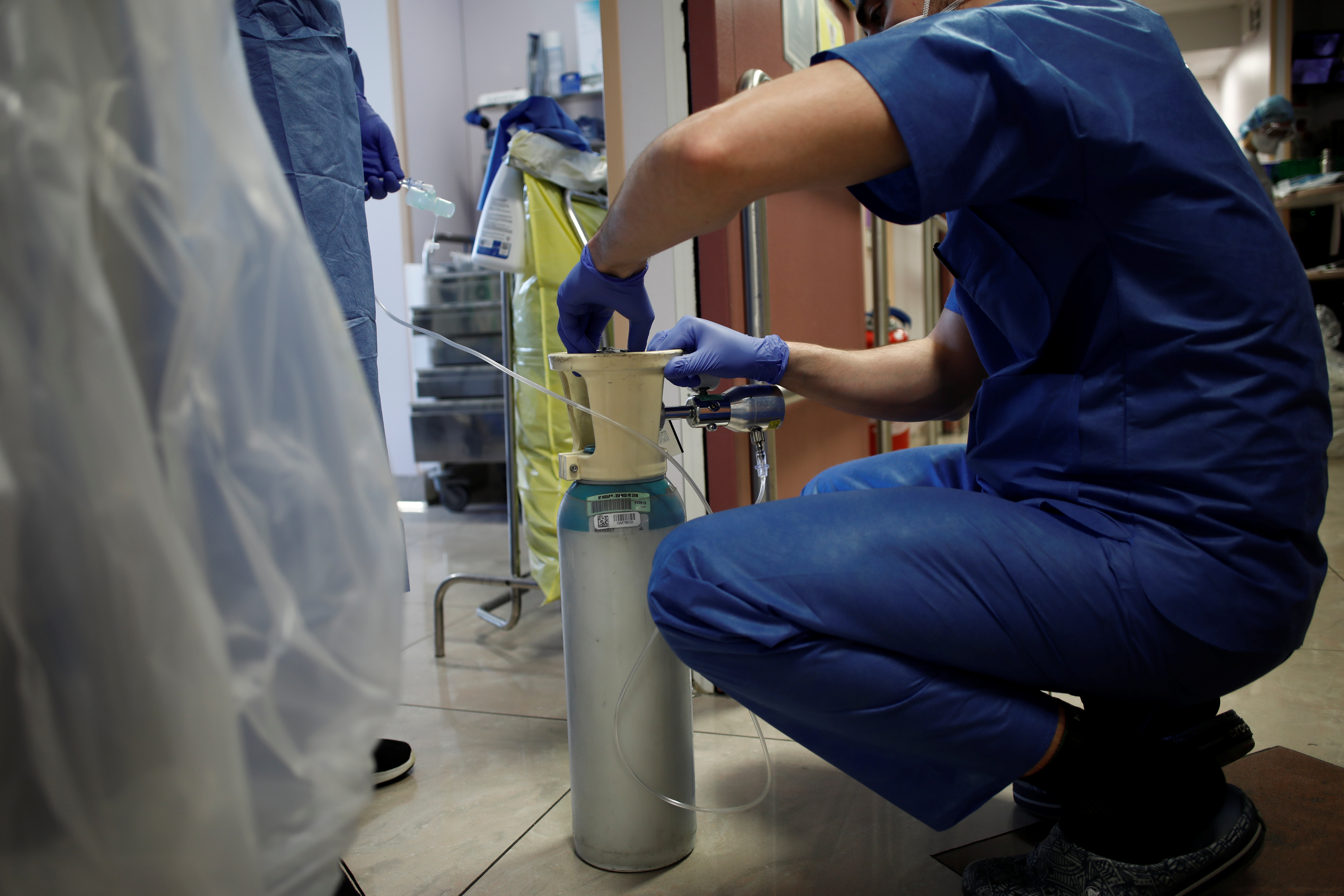 A member of medical staff checks an oxygen bottle at the intensive care unit for coronavirus disease (COVID-19) patients at Ambroise Pare clinic in Neuilly-sur-Seine near Paris, as the spread of the coronavirus disease continues in France, April 1, 2020. REUTERS/Benoit Tessier
