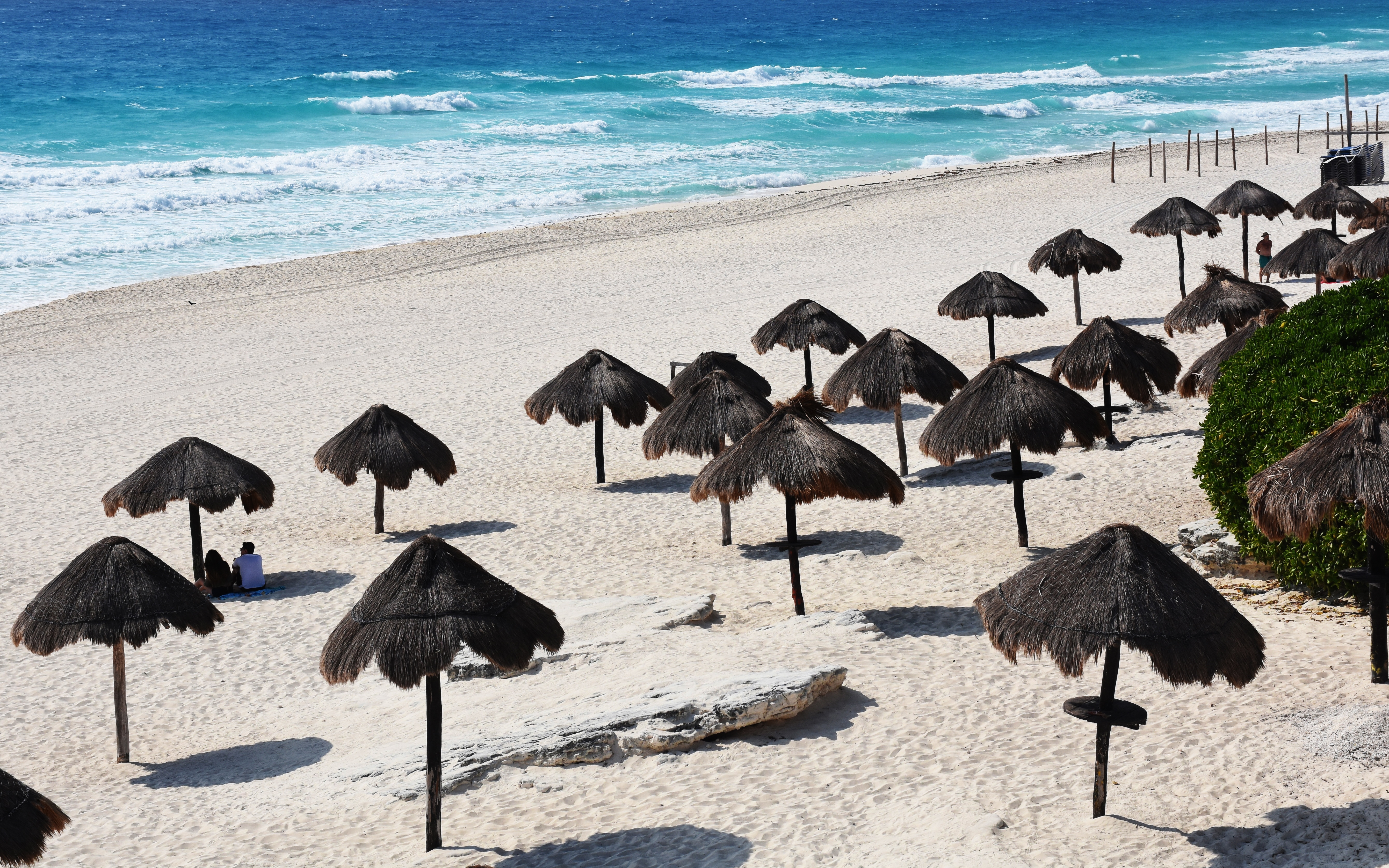 Una pareja solitaria de turistas disfruta de la playa en Cancún, estado de Quintana Roo, México, el 28 de marzo de 2020.