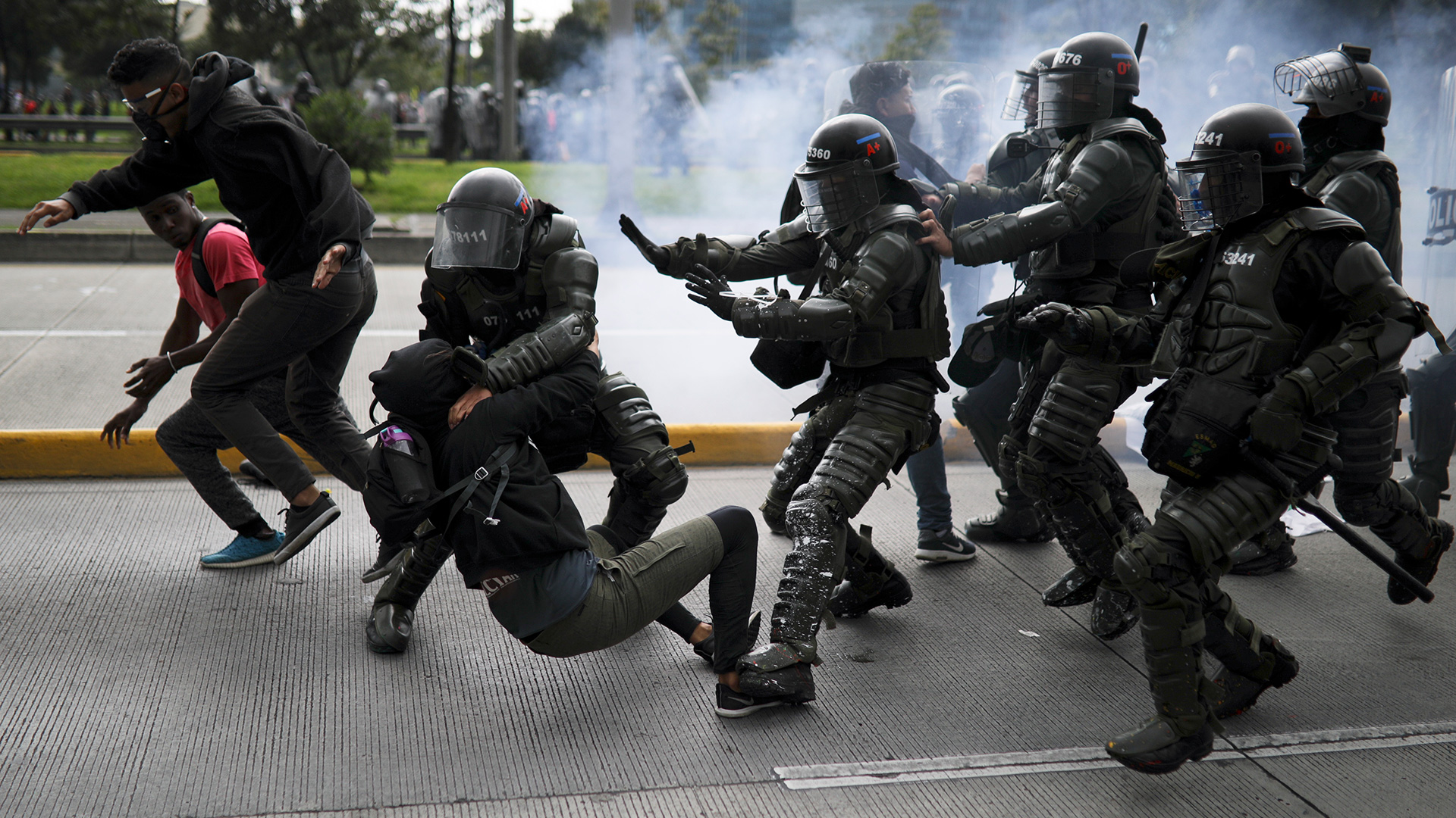 Police detain an anti-government demonstrator during a nationwide strike in Bogota, Colombia, Thursday, Nov. 21, 2019. Colombia's main union groups and student activists called for a strike to protest the economic policies of Colombian President Ivan Duque government and a long list of grievances. (AP Photo/Ivan Valencia)