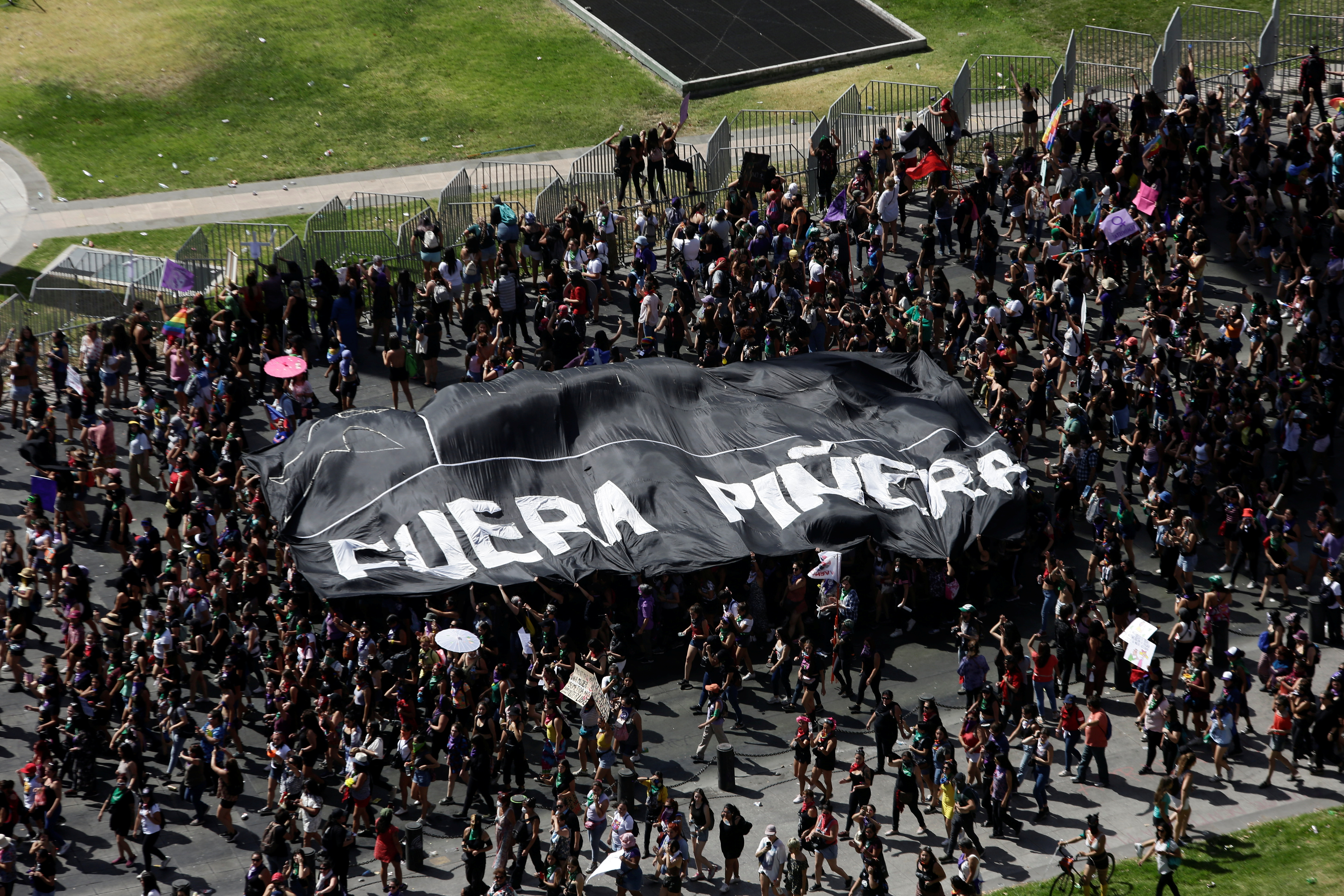 Las manifestantes sostienen una pancarta que dice