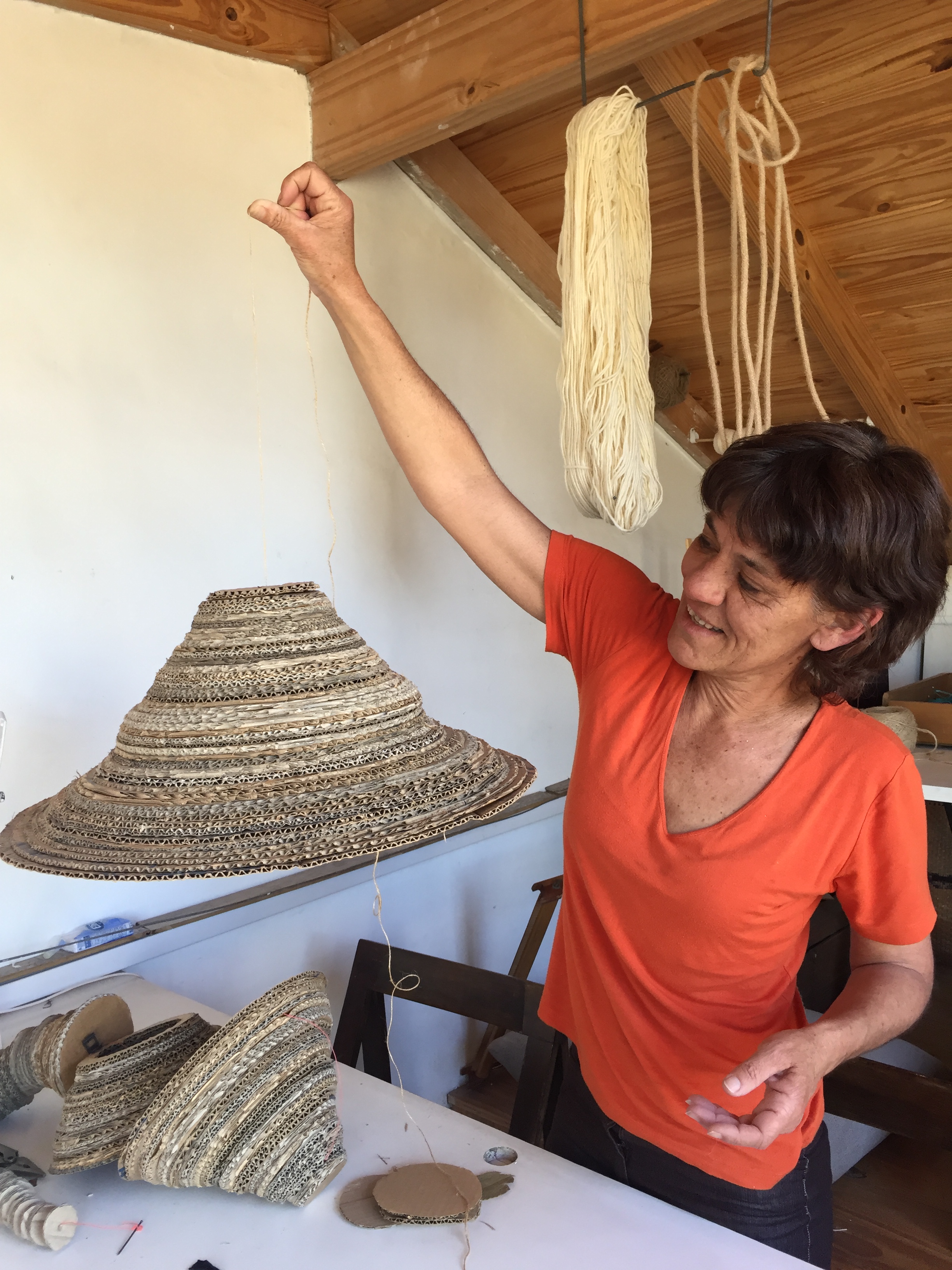 La diseñadora Flavia Hogg utiliza el cartón desechado para crear lámparas, bancos, mesas, y objetos deco. Tiene etapas en las que trabaja con alambre, piedras, fósforos, ramas y, además, da clases de telar