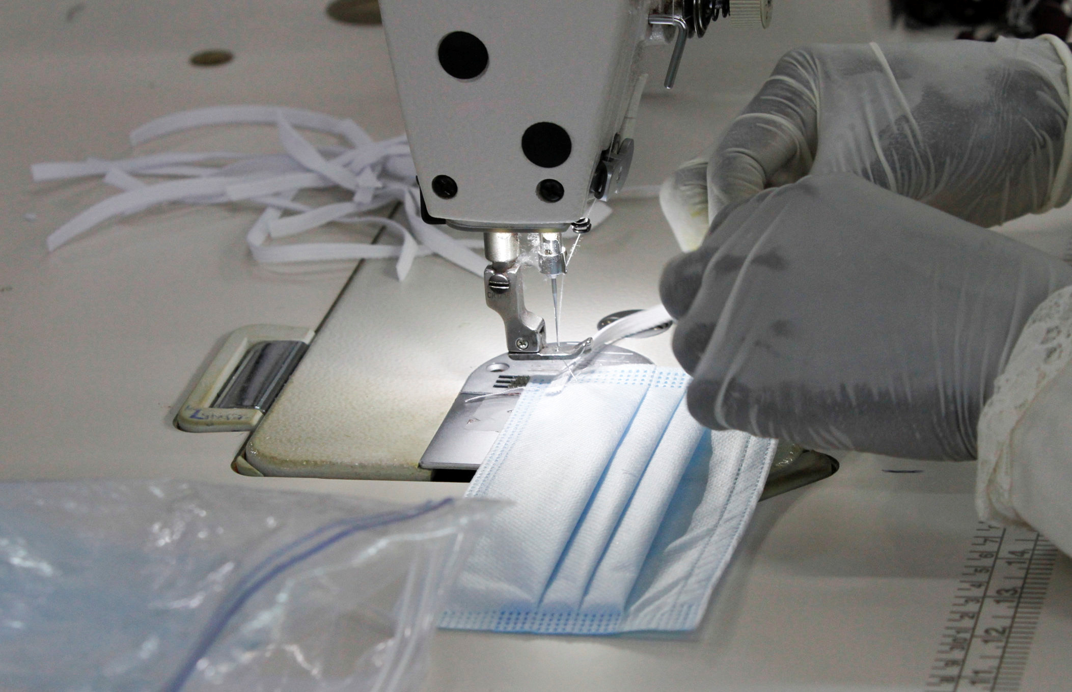 A worker stitches a protective face mask at a production line within the Shona Textiles Export Processing Zone (EPZ), as a measure to stem the coronavirus disease (COVID-19) outbreak, in Athi River near Nairobi, Kenya April 14, 2020. REUTERS/Njeri Mwangi