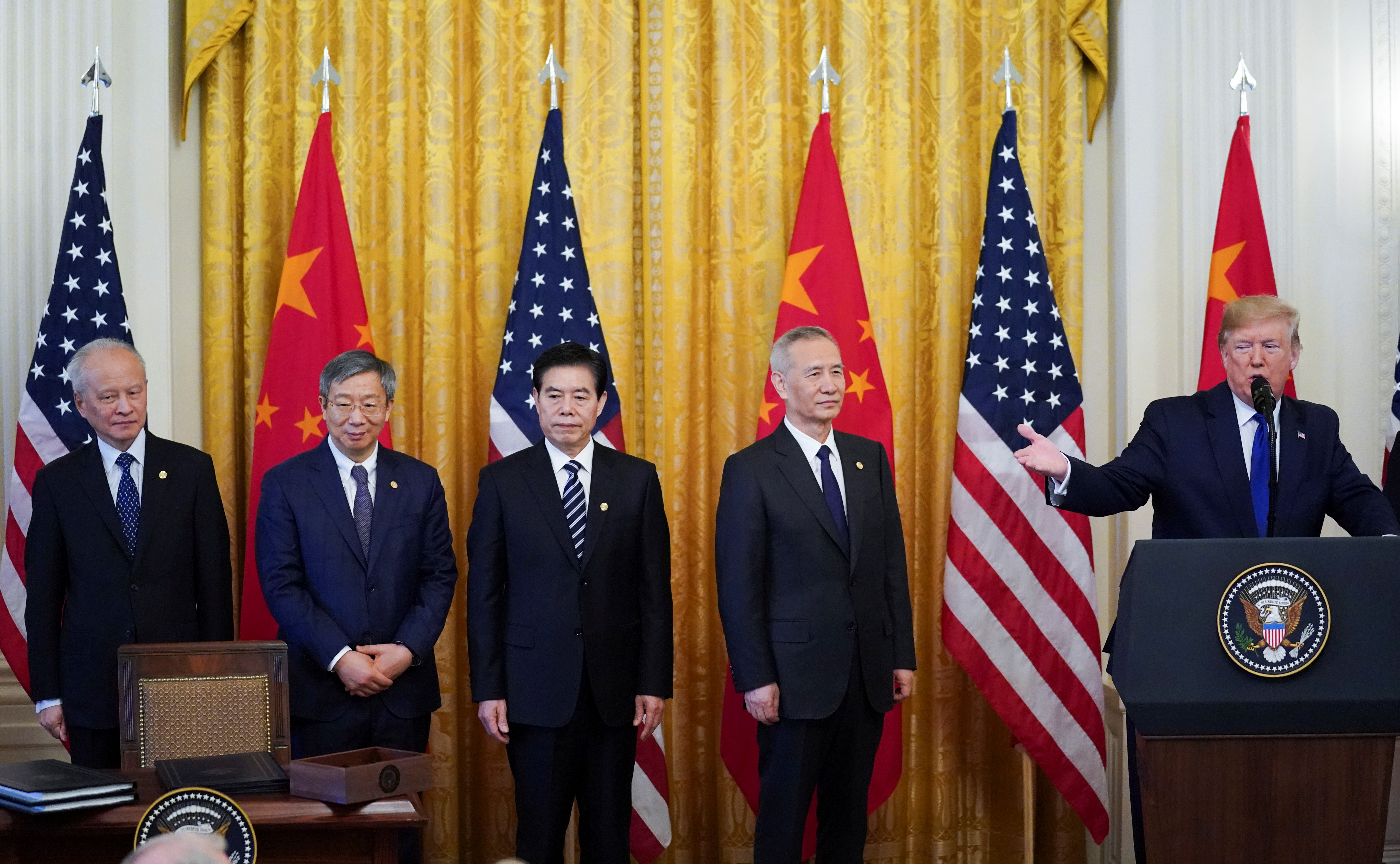 Viceprimer ministro chino Liu He y su equipo escuchan al presidente de Estados Unidos Donald Trump mientras habla al comienzo de la ceremonia de firma de la "fase uno" del acuerdo (REUTERS/Kevin Lamarque)