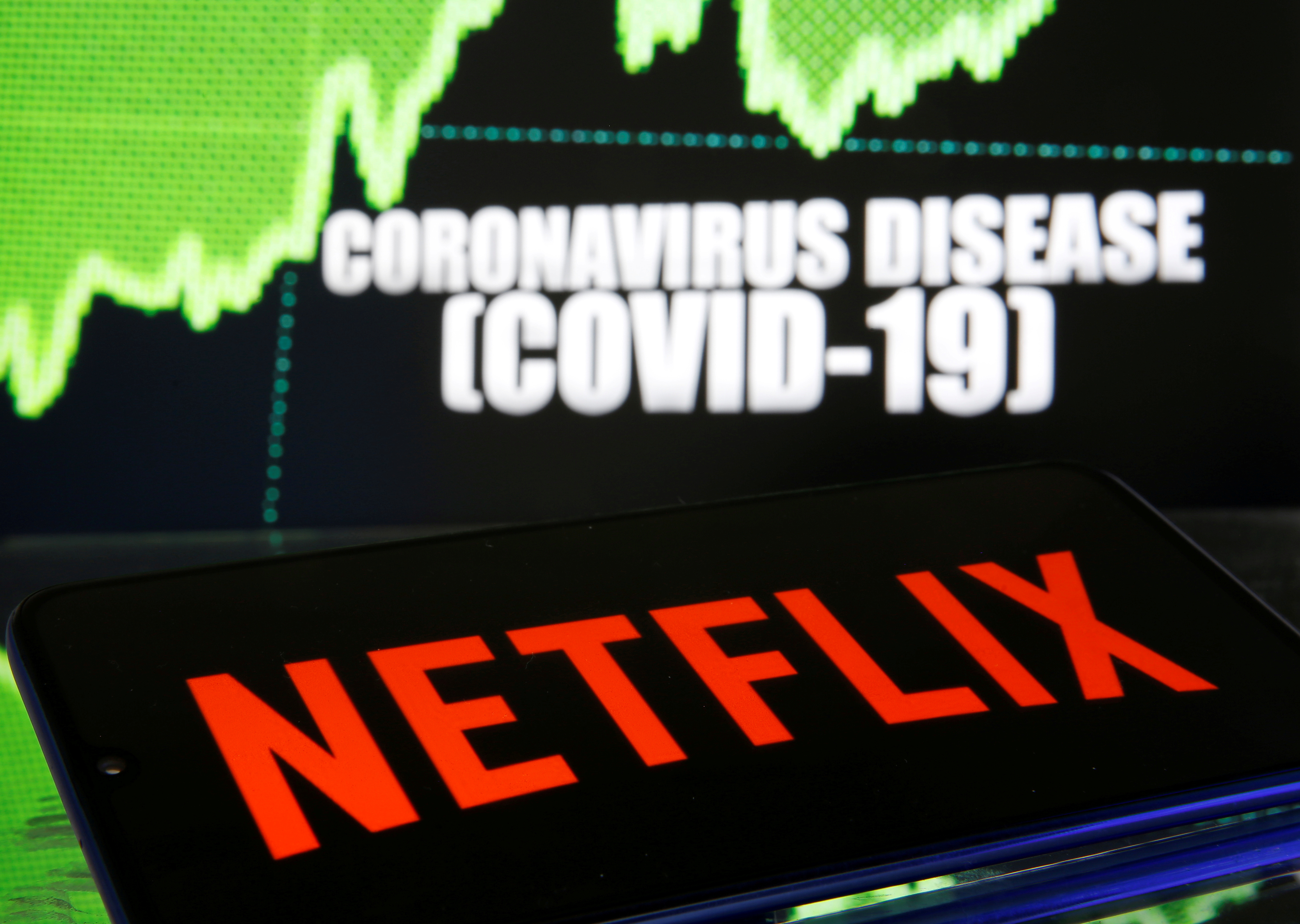 FILE PHOTO: Netflix logo is seen in front of diplayed coronavirus disease (COVID-19) in this illustration taken March 19, 2020. REUTERS/Dado Ruvic/Illustration/File Photo