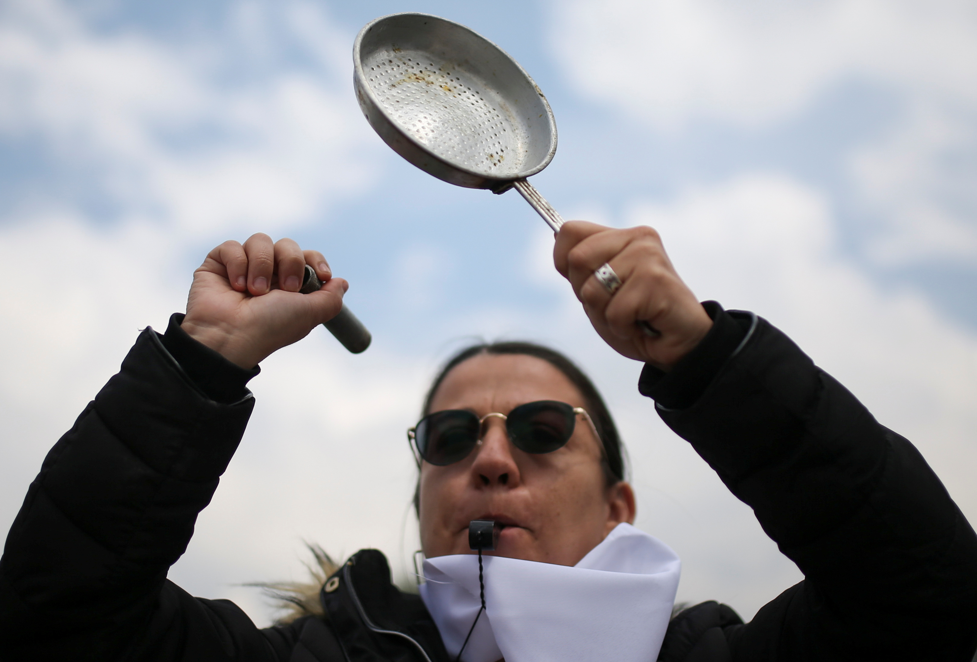 A demonstrator bangs a pot during a protest for a national strike, in Bogota, Colombia, November 21, 2019. REUTERS/Luisa Gonzalez