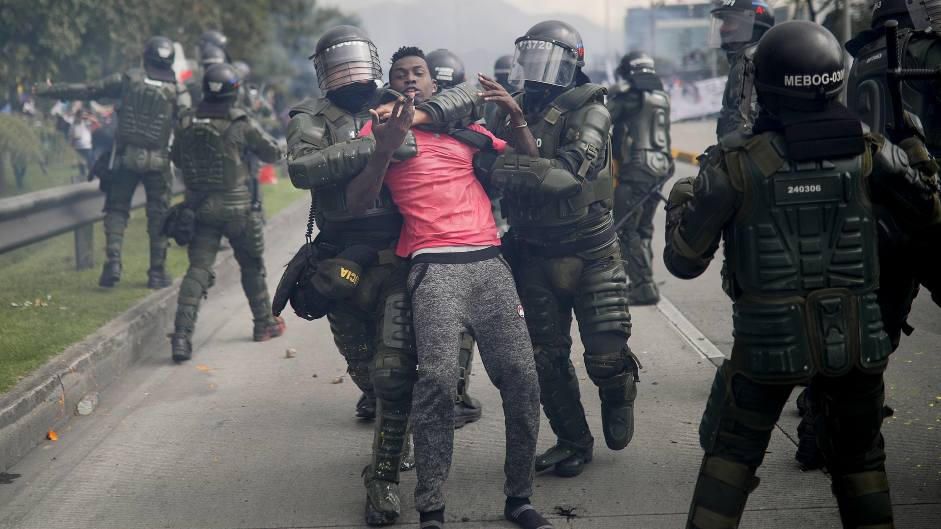 Police detain an anti-government demonstrator during a nationwide strike in Bogota, Colombia, Thursday, Nov. 21, 2019. Colombia's main union groups and student activists called for a strike to protest the economic policies of Colombian President Ivan Duque government and a long list of grievances. (AP Photo/Ivan Valencia)