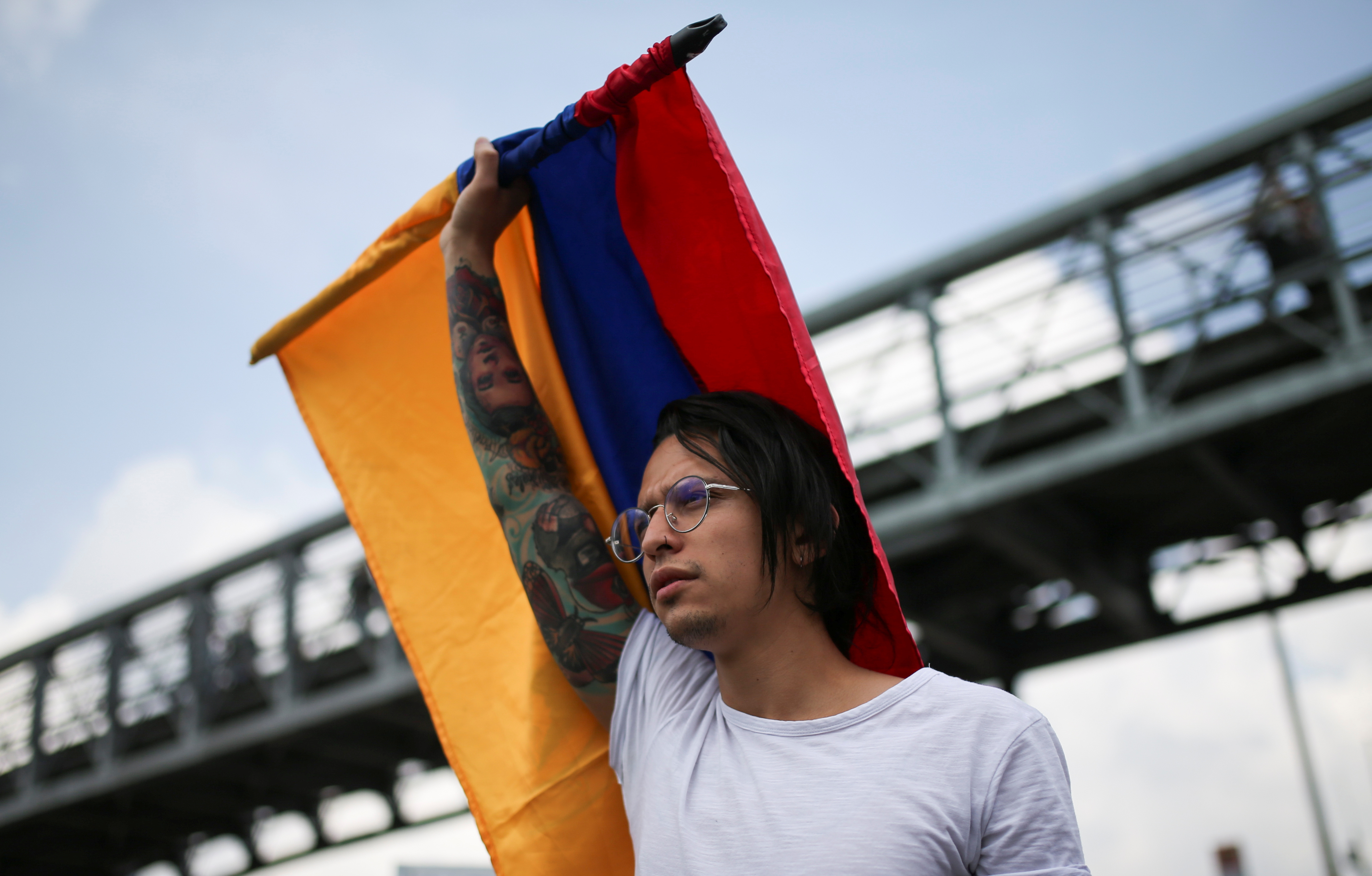 A demonstrator holds a Colombian flag during a protest for a national strike, in Bogota, Colombia, November 21, 2019. REUTERS/Luisa Gonzalez