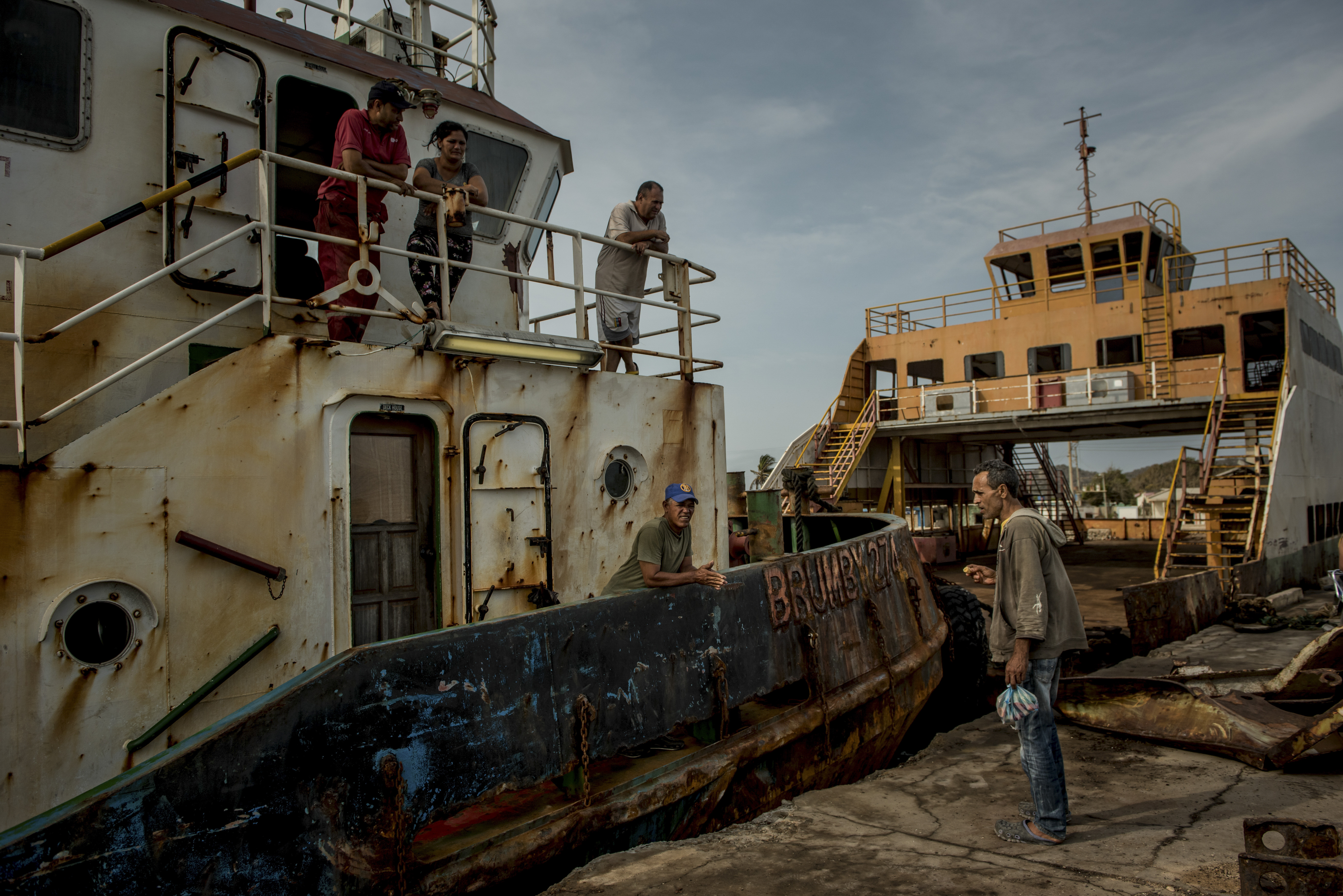 Un barco petrolero arrastra el ferry oxidado desde la Isla de Toas hacia el continente para conseguir escasas cantidades de alimentos subsidiados. . (Meridith Kohut/The New York Times)