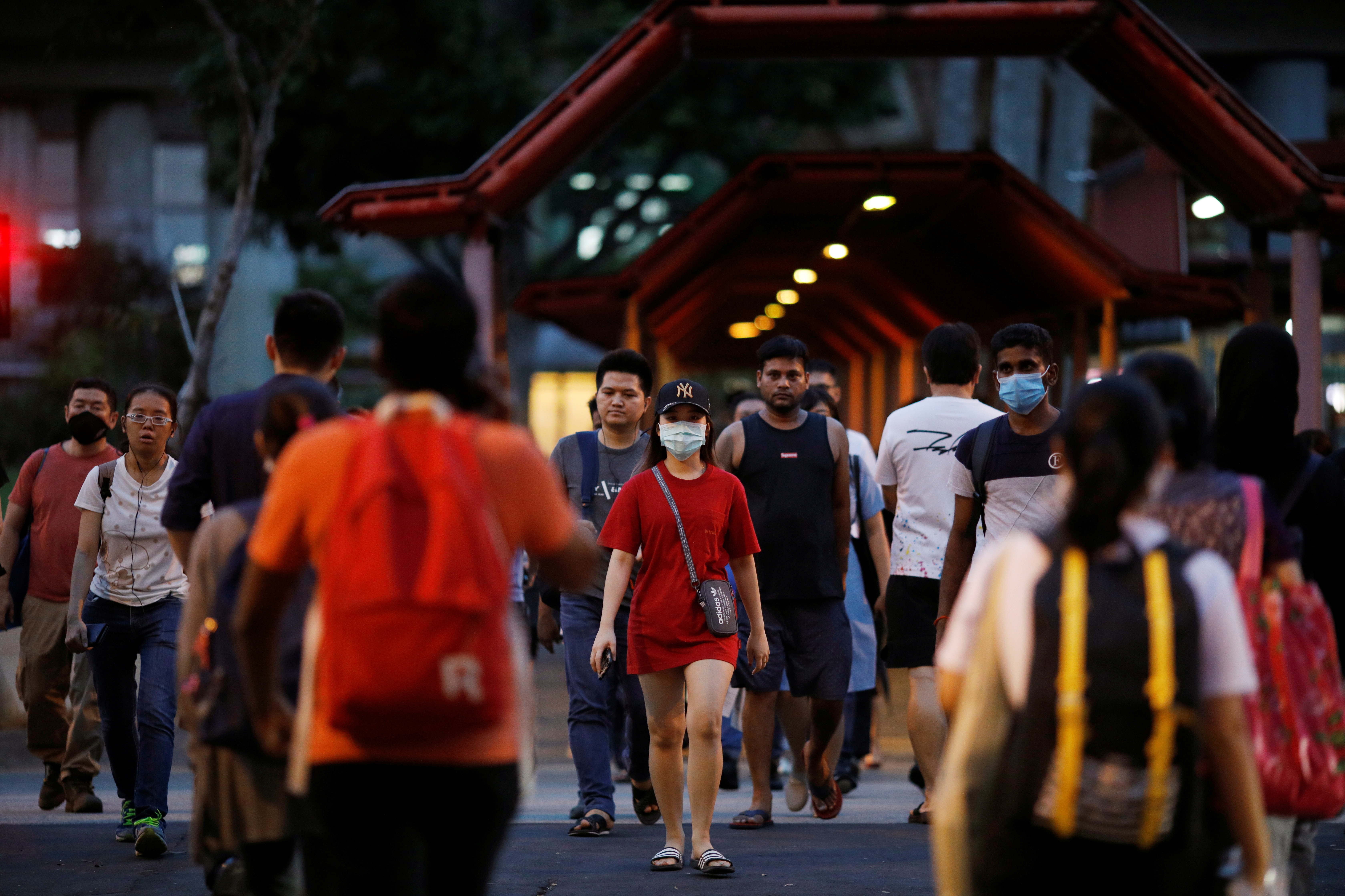 People wear face masks during the outbreak of coronavirus disease (COVID-19) in Singapore, April 3, 2020. REUTERS/Edgar Su