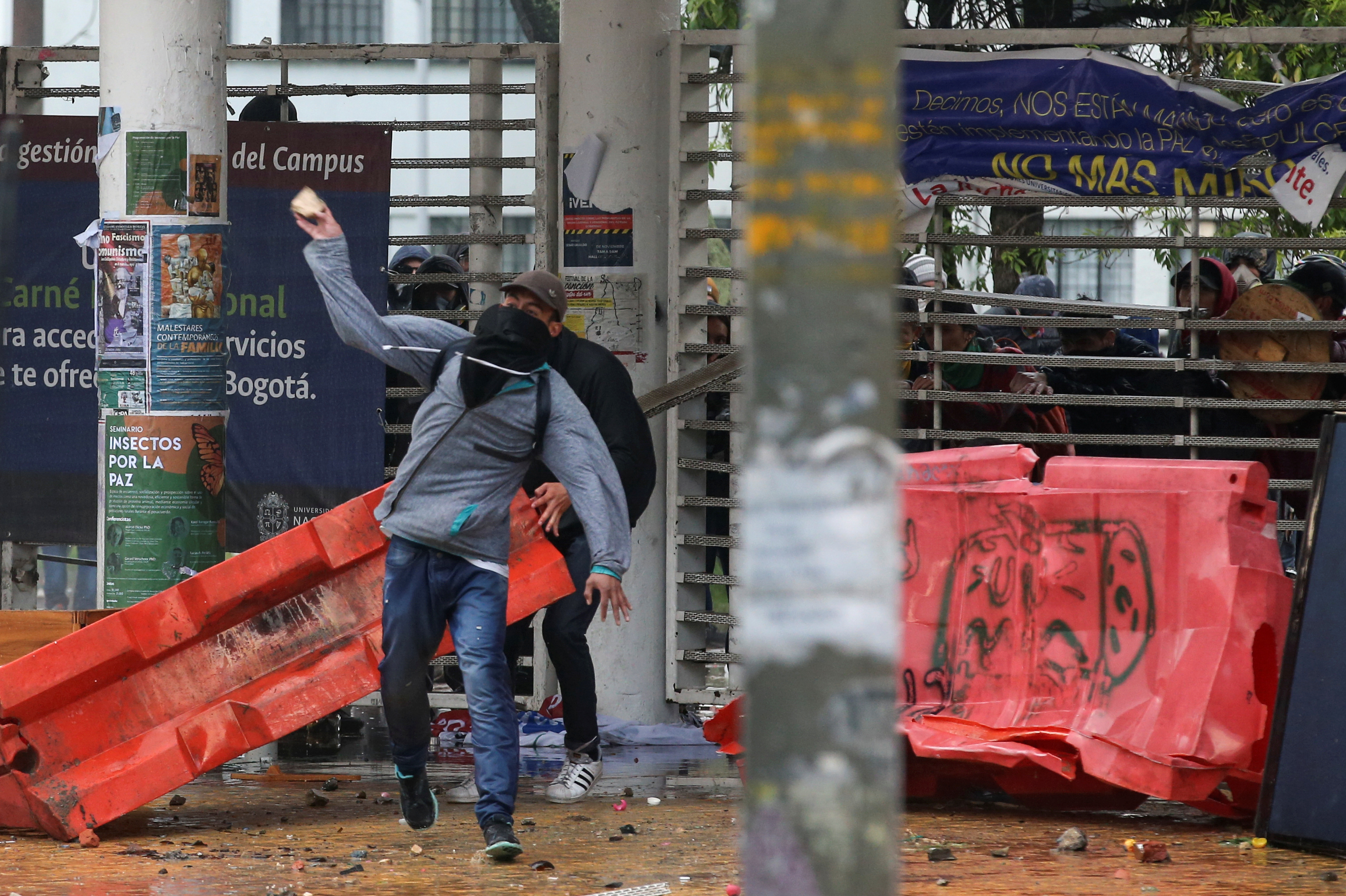 A demonstrator throws a stone during a protest in Bogota, Colombia, November 21, 2019. REUTERS/Luisa Gonzalez