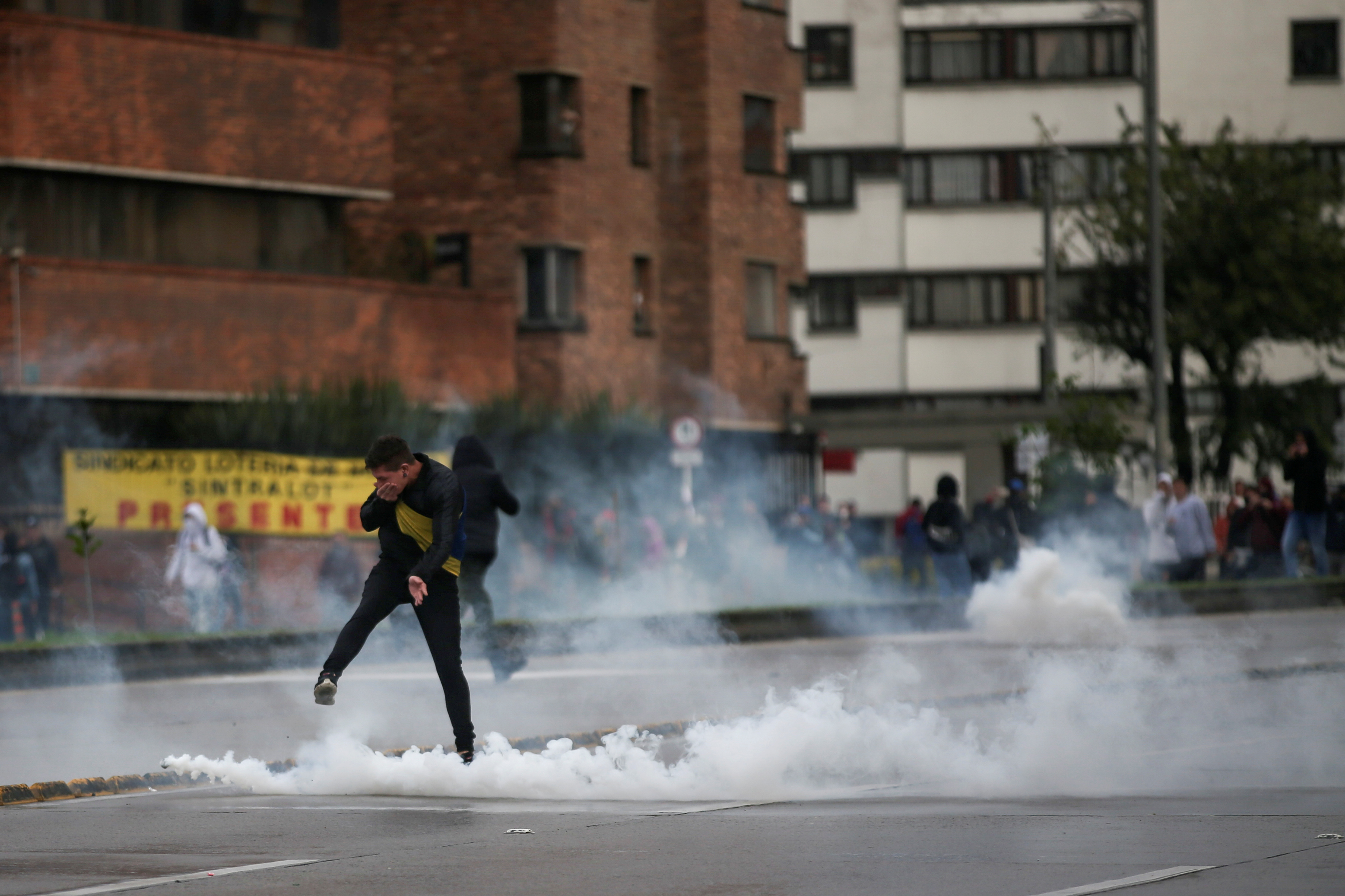 A demonstrator kicks back a tear gas canister during a protest in Bogota, Colombia, November 21, 2019. REUTERS/Luisa Gonzalez